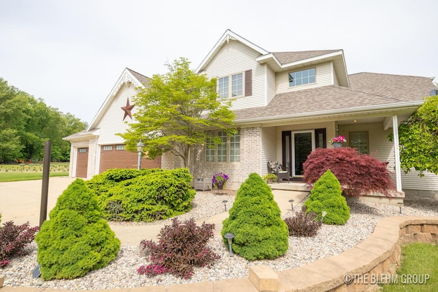 1705 Fritz St, Marne, MI 49435 - traditional home featuring a porch, a shingled roof, a garage, and driveway
