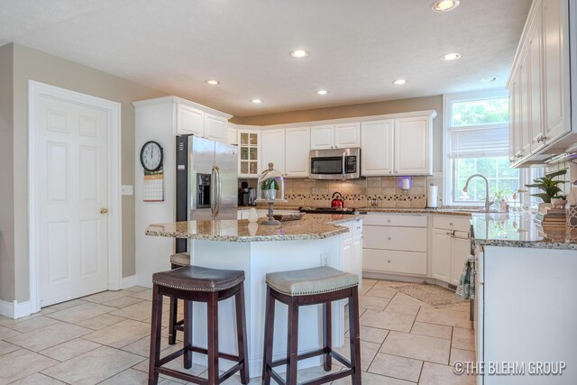 1705 Fritz St, Marne, MI 49435 - kitchen with a sink, appliances with stainless steel finishes, backsplash, recessed lighting, and white cabinetry