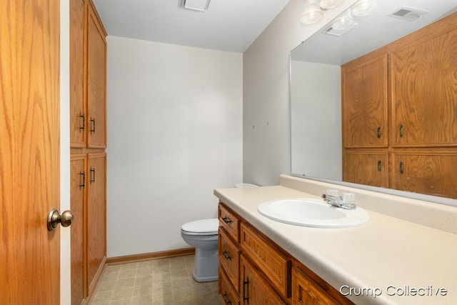 2870 S Wentward Ct, Hudsonville, MI 49426 - bathroom with vanity, toilet, baseboards, and tile patterned floors