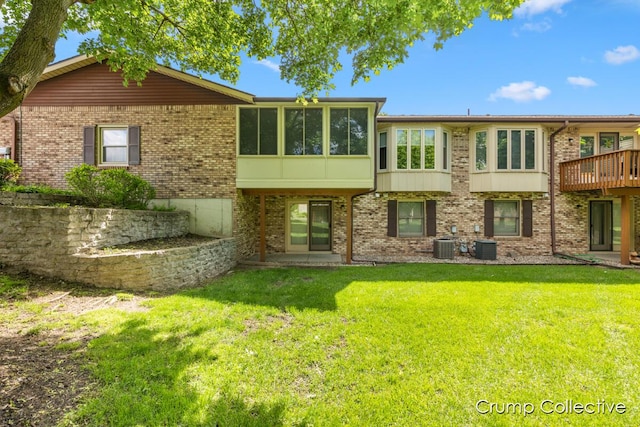 2870 S Wentward Ct, Hudsonville, MI 49426 - rear view of house with a lawn, a sunroom, brick siding, and central AC