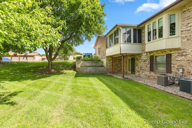 2870 S Wentward Ct, Hudsonville, MI 49426 - view of grassy yard with central AC unit and a sunroom