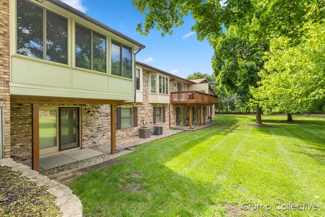 2870 S Wentward Ct, Hudsonville, MI 49426 - view of grassy yard with central AC and a wooden deck