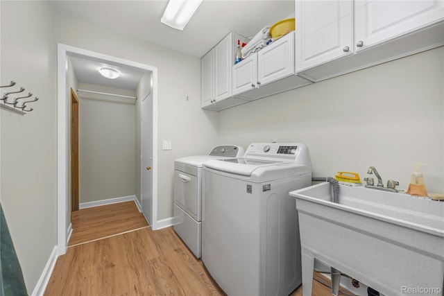 29832 High Valley Ct, Farmington Hills, MI 48331 - laundry room featuring cabinet space, washer and dryer, and light wood-style flooring