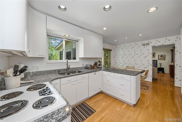 29832 High Valley Ct, Farmington Hills, MI 48331 - kitchen with range, white cabinets, a peninsula, light wood-style flooring, and recessed lighting