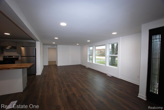 12357 Raymond Dr, Clio, MI 48420 - unfurnished living room with recessed lighting, dark wood-style flooring, and baseboards