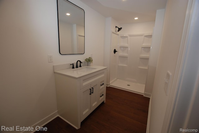 12357 Raymond Dr, Clio, MI 48420 - bathroom with vanity, wood finished floors, a shower, recessed lighting, and baseboards