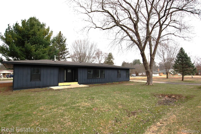 12357 Raymond Dr, Clio, MI 48420 - view of front of home with board and batten siding and a front yard