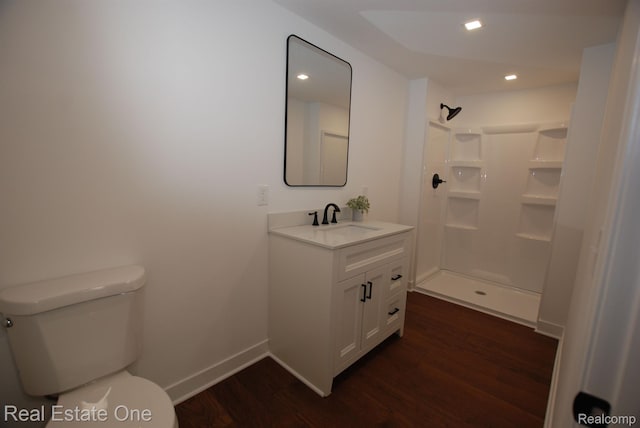 12357 Raymond Dr, Clio, MI 48420 - full bathroom featuring wood finished floors, toilet, vanity, a shower, and baseboards