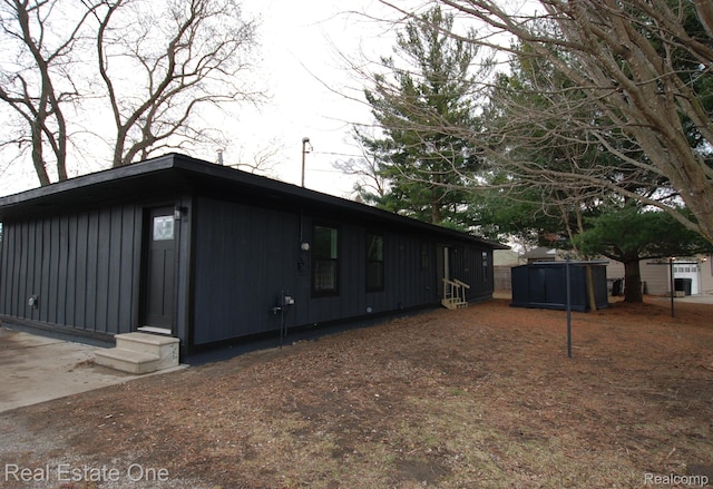 12357 Raymond Dr, Clio, MI 48420 - view of side of property featuring board and batten siding and entry steps