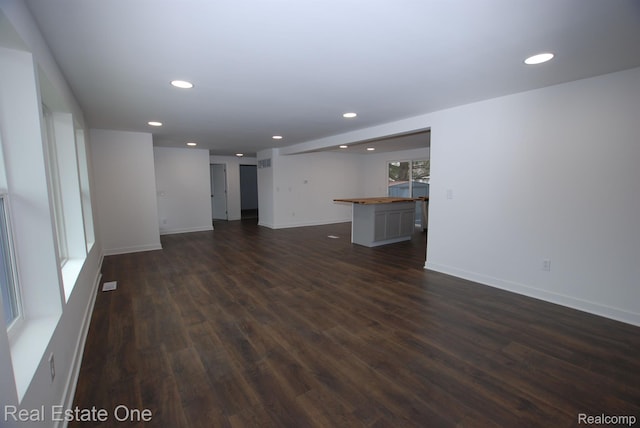 12357 Raymond Dr, Clio, MI 48420 - unfurnished living room featuring dark wood-style flooring, recessed lighting, and baseboards