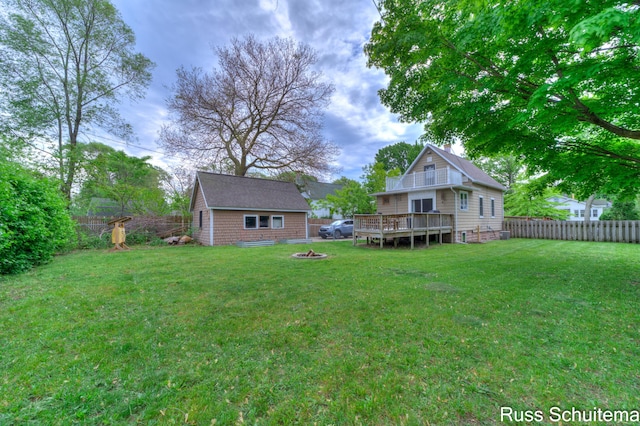 1227 Columbus Ave, Grand Haven, MI 49417 - view of yard with a wooden deck, an outdoor fire pit, and an outbuilding