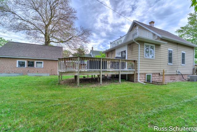 1227 Columbus Ave, Grand Haven, MI 49417 - back of house with a balcony, a chimney, central AC, a yard, and a wooden deck