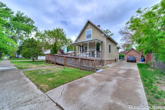 1227 Columbus Ave, Grand Haven, MI 49417 - view of front of home featuring a porch, concrete driveway, a chimney, an outbuilding, and a garage