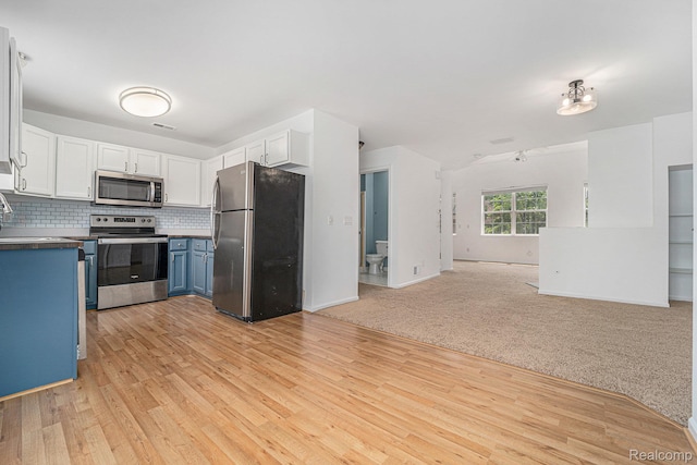 170 Allenhurst Ave, Royal Oak, MI 48067 - kitchen featuring appliances with stainless steel finishes, open floor plan, blue cabinetry, dark countertops, and white cabinetry