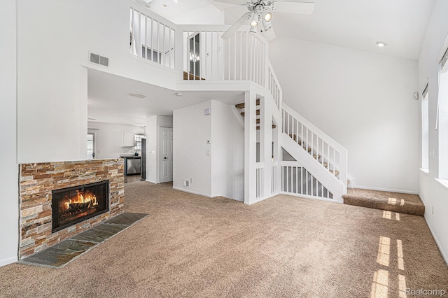 170 Allenhurst Ave, Royal Oak, MI 48067 - unfurnished living room with high vaulted ceiling, carpet flooring, a ceiling fan, a stone fireplace, and stairs