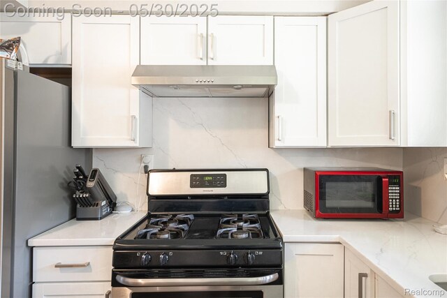 7265 Hillside Dr, Dearborn, MI 48127 - kitchen with stainless steel appliances, under cabinet range hood, tasteful backsplash, and white cabinets