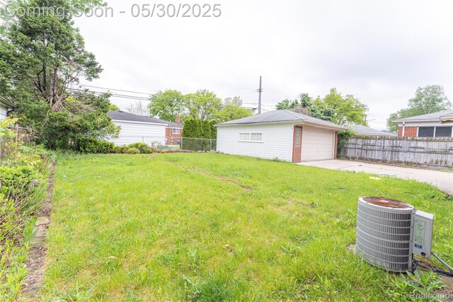 7265 Hillside Dr, Dearborn, MI 48127 - view of yard with central AC, driveway, an outdoor structure, and a detached garage