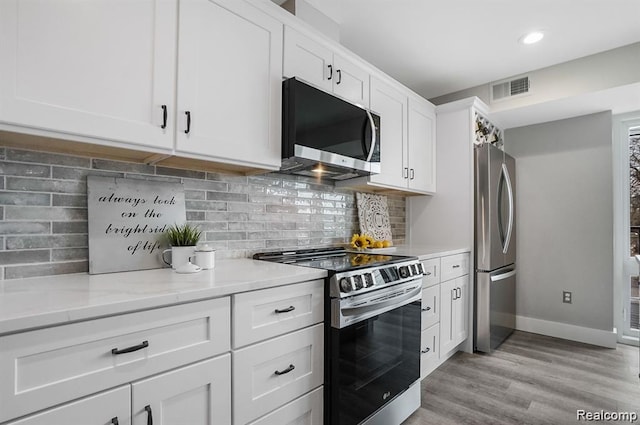 344 Main St Unit 300, Milford, MI 48381 - kitchen with stainless steel appliances, baseboards, white cabinetry, light wood-style floors, and recessed lighting