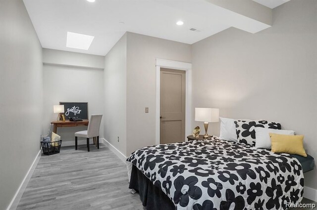 344 Main St Unit 300, Milford, MI 48381 - bedroom featuring a skylight, wood finished floors, baseboards, a desk, and recessed lighting