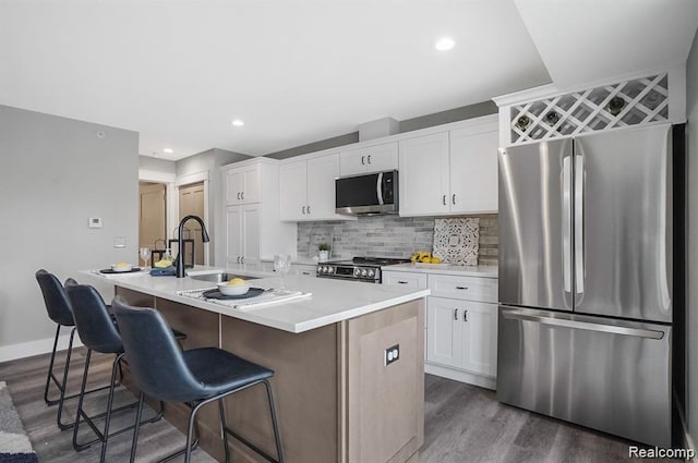 344 Main St Unit 300, Milford, MI 48381 - kitchen with stainless steel appliances, dark wood-style flooring, a sink, a kitchen island with sink, and recessed lighting