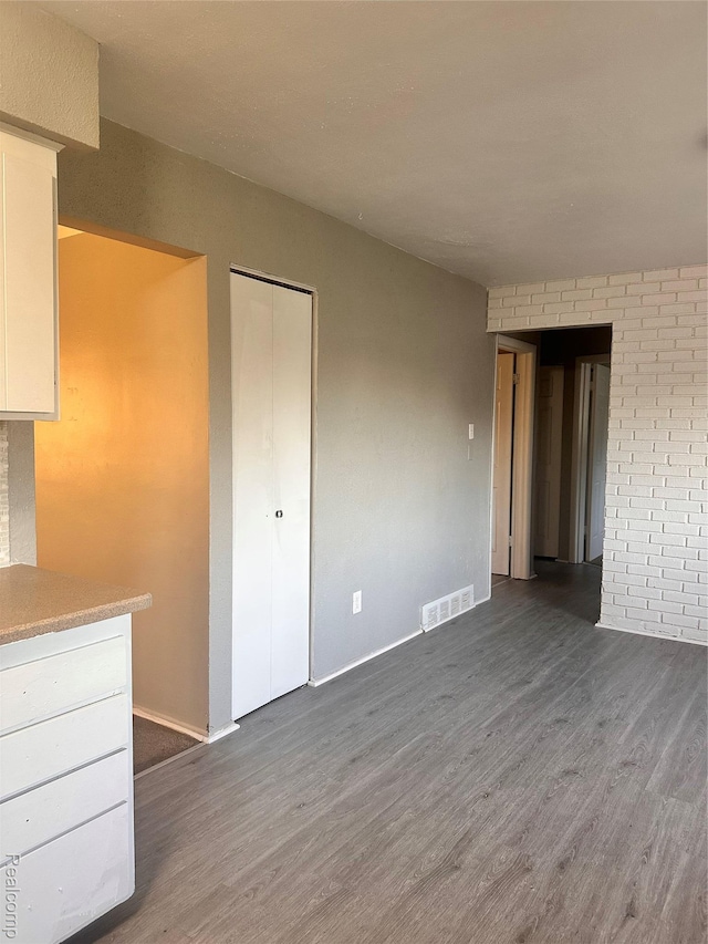 26304 Patricia Ave, Sterling Heights, MI 48091 - unfurnished living room featuring wood finished floors and baseboards