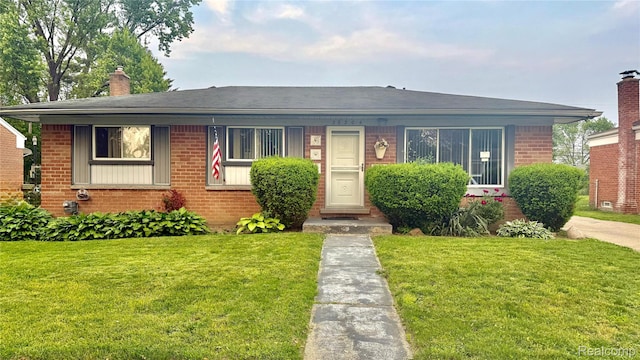 26304 Patricia Ave, Sterling Heights, MI 48091 - bungalow featuring brick siding, a chimney, and a front yard