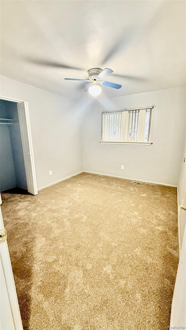26304 Patricia Ave, Sterling Heights, MI 48091 - unfurnished bedroom featuring carpet flooring, ceiling fan, a closet, and baseboards