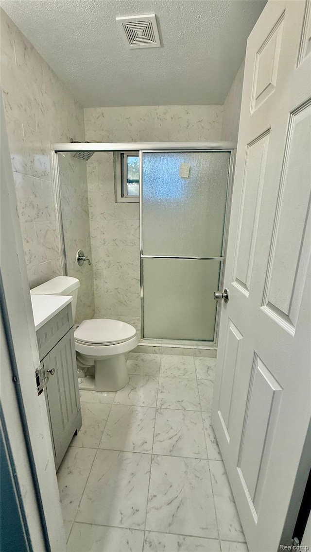 26304 Patricia Ave, Sterling Heights, MI 48091 - full bathroom with marble look tile flooring, toilet, a shower stall, a textured ceiling, and vanity