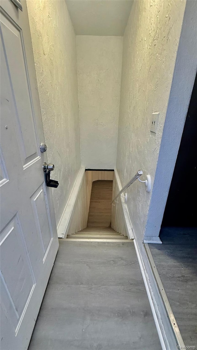26304 Patricia Ave, Sterling Heights, MI 48091 - staircase featuring a textured wall and wood finished floors