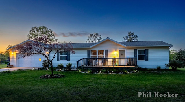 105 Penny Ln, Stanton, MI 48888 - ranch-style house with an attached garage, a yard, driveway, and a wooden deck