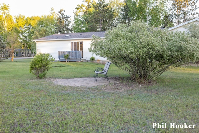 105 Penny Ln, Stanton, MI 48888 - rear view of house with a lawn and a deck