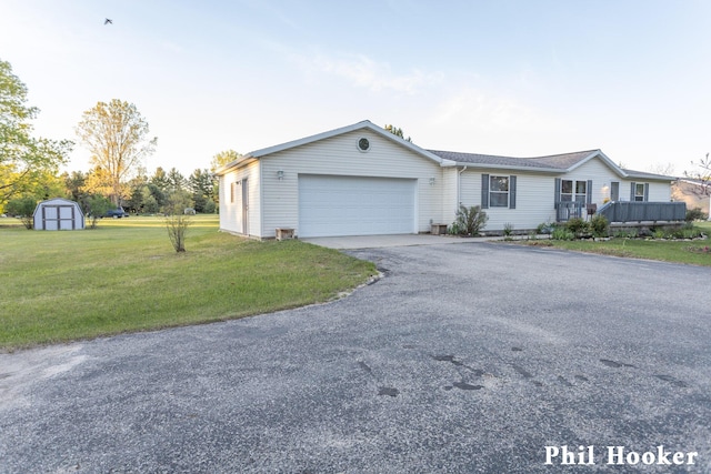 105 Penny Ln, Stanton, MI 48888 - single story home featuring an attached garage, a front lawn, and asphalt driveway