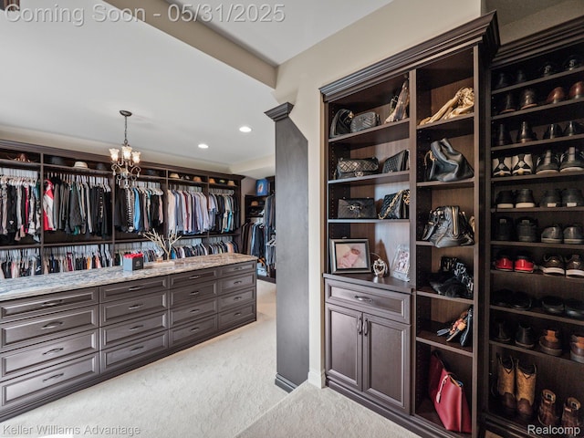 20971 Pomino Dr, Northville, MI 48167 - spacious closet featuring light colored carpet and a chandelier