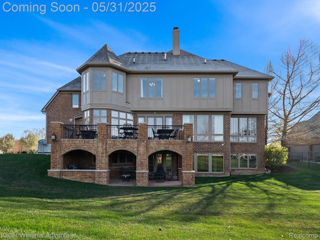 20971 Pomino Dr, Northville, MI 48167 - rear view of house featuring a patio area, a chimney, brick siding, and a yard