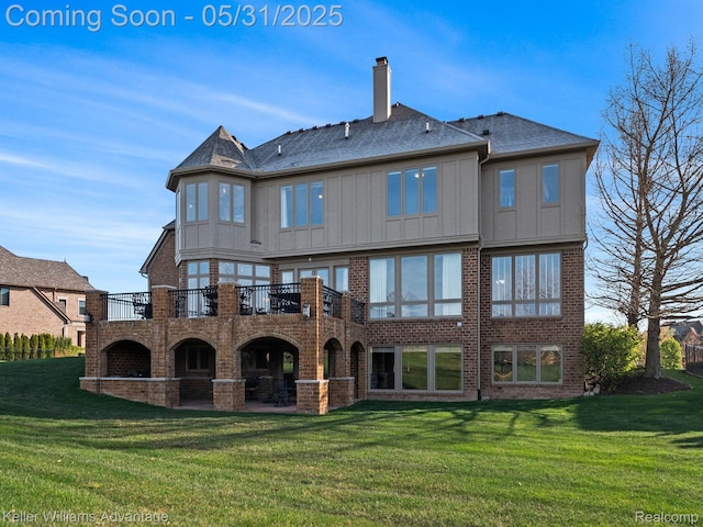 20971 Pomino Dr, Northville, MI 48167 - rear view of house featuring a yard, a chimney, and brick siding