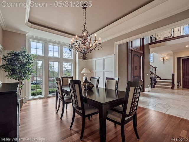 20971 Pomino Dr, Northville, MI 48167 - dining room with a chandelier, healthy amount of natural light, ornamental molding, stairs, and a towering ceiling
