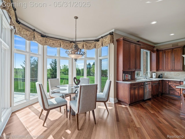 20971 Pomino Dr, Northville, MI 48167 - dining area featuring plenty of natural light, dark wood-style flooring, ornamental molding, recessed lighting, and baseboards