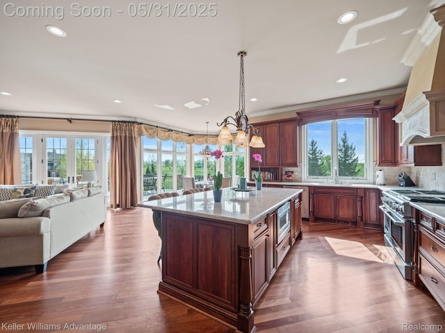 20971 Pomino Dr, Northville, MI 48167 - kitchen with appliances with stainless steel finishes, open floor plan, ornamental molding, a sink, and pendant lighting