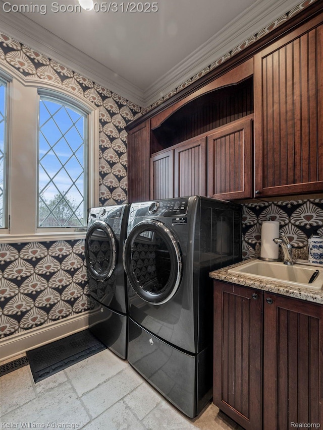 20971 Pomino Dr, Northville, MI 48167 - laundry room featuring cabinet space, washing machine and dryer, crown molding, stone tile floors, and wallpapered walls