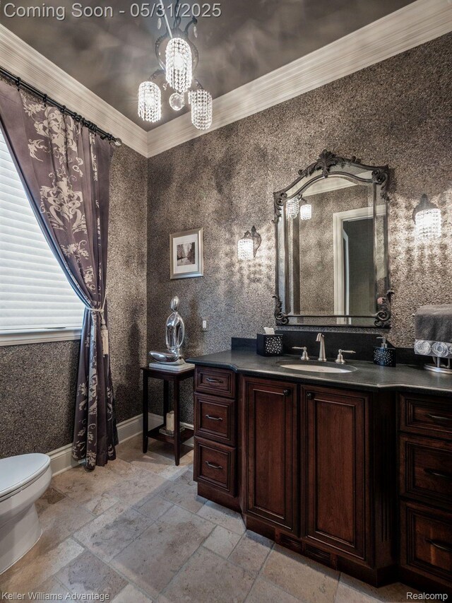 20971 Pomino Dr, Northville, MI 48167 - bathroom with toilet, a chandelier, vanity, stone tile flooring, and crown molding