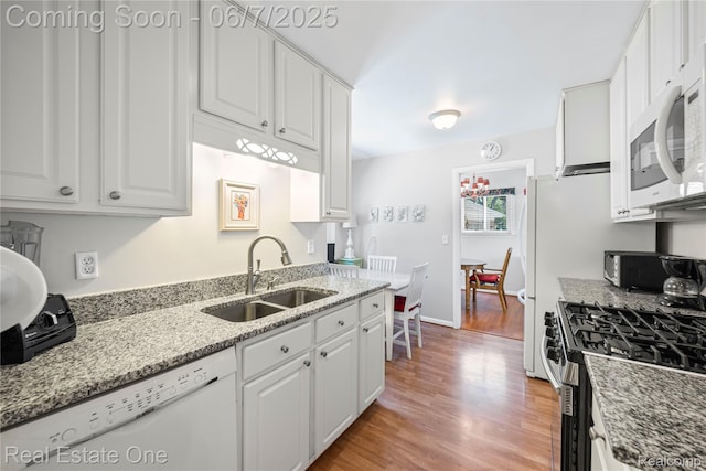 2253 Robell Dr, Commerce Twp, MI 48390 - kitchen with a sink, white appliances, white cabinets, and wood finished floors