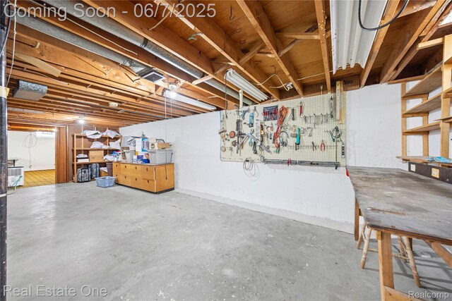 2253 Robell Dr, Commerce Twp, MI 48390 - unfinished basement with a workshop area