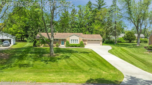 2253 Robell Dr, Commerce Twp, MI 48390 - view of front of house with concrete driveway, a garage, and a front yard