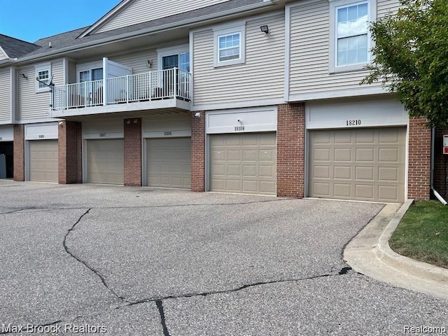 16211 Addington Dr Unit 192, Commerce Twp, MI 48390 - view of front facade with brick siding and an attached garage