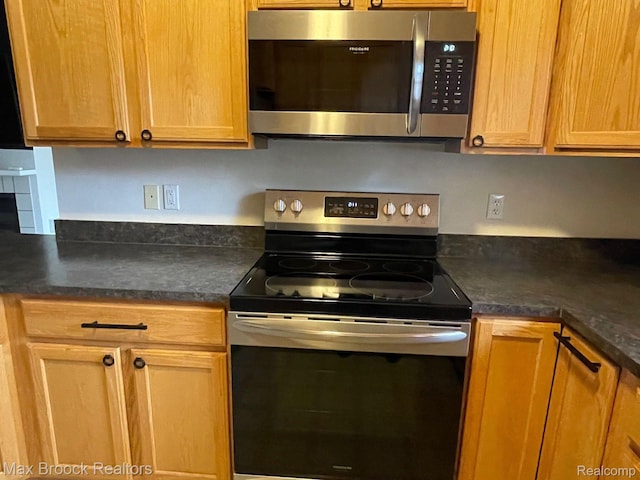 16211 Addington Dr Unit 192, Commerce Twp, MI 48390 - kitchen with appliances with stainless steel finishes and dark countertops