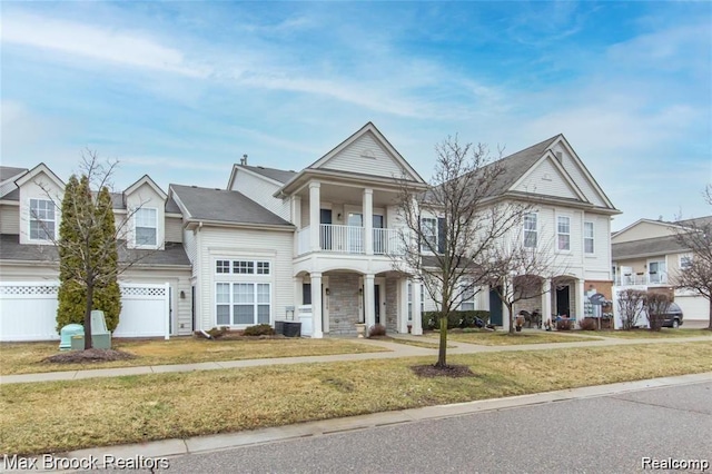 16211 Addington Dr Unit 192, Commerce Twp, MI 48390 - view of front of property featuring a balcony, stone siding, central AC unit, and covered porch