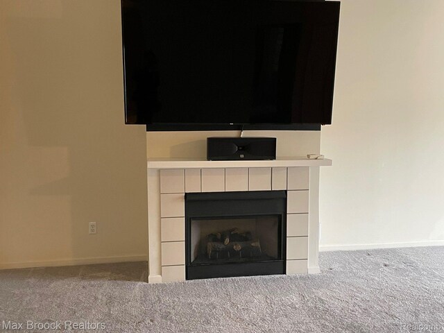 16211 Addington Dr Unit 192, Commerce Twp, MI 48390 - detailed view of carpet floors, baseboards, and a tile fireplace