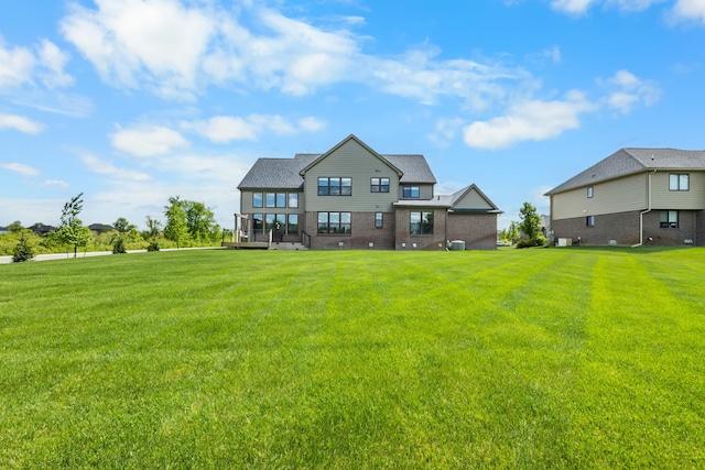 2349 Westbrooke Ct, Ann Arbor, MI 48105 - rear view of property with a lawn and brick siding