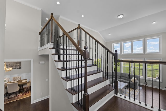 2349 Westbrooke Ct, Ann Arbor, MI 48105 - stairway featuring wood finished floors, high vaulted ceiling, baseboards, ornamental molding, and a chandelier