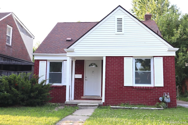 15243 Eastwood St, Detroit, MI 48205 - bungalow featuring a chimney, brick siding, and a shingled roof